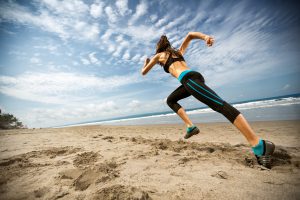 Woman running on the beach, fitness and health care concept